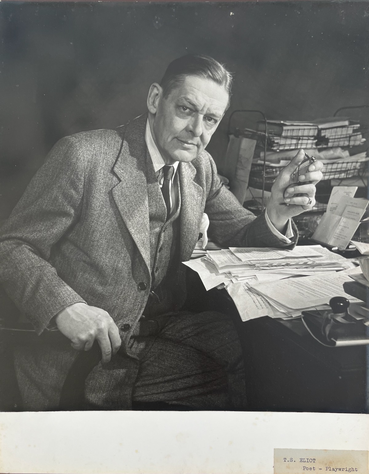 THOMAS STEARNS ELIOT. English Poet, Playwright and Essayist. At his desk 1888 - 1965. Photographed by DOUGLAS GLASS.