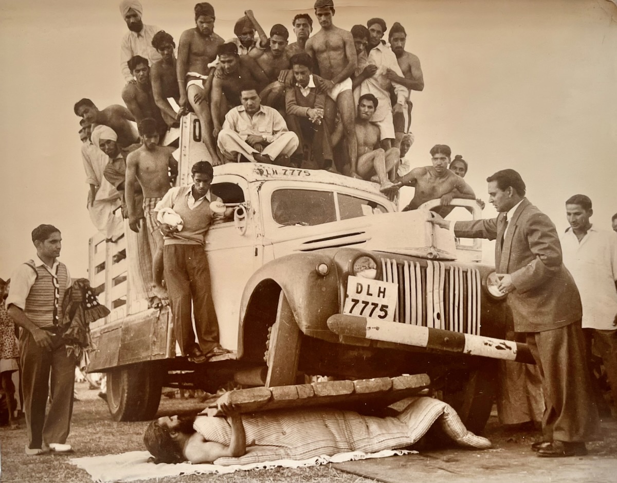 [Photograph] Indian Vegetarian and Yogi expert Swami Dev Murti, lies on a bed of broken glass as a heavy lorry with fifty passengers on it is driven over his body at the Fifteenth World Vegetarian Congress in New Delhi, India, November 16.