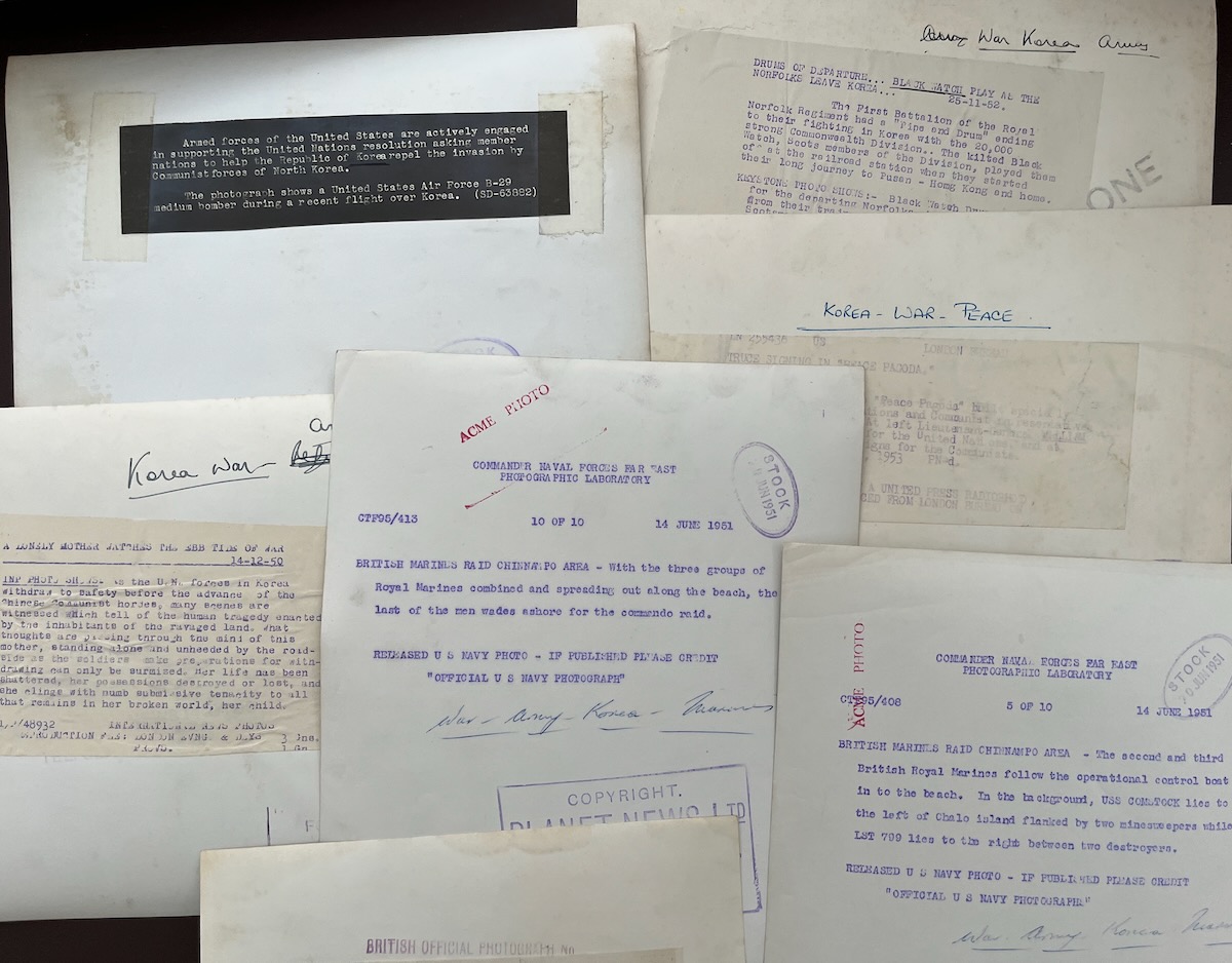 Collection of 23 press photographs and one cartoon.